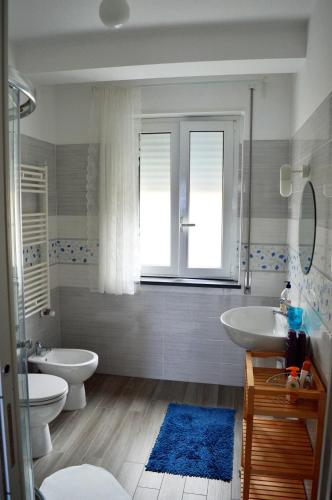 a bathroom with two sinks and two toilets at Marina Holiday Home in Pizzo