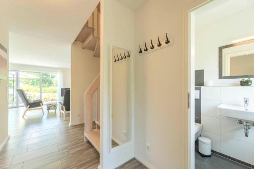 a bathroom with a sink and a mirror at Ferienhaus-Belvedere-2-c in Blekendorf