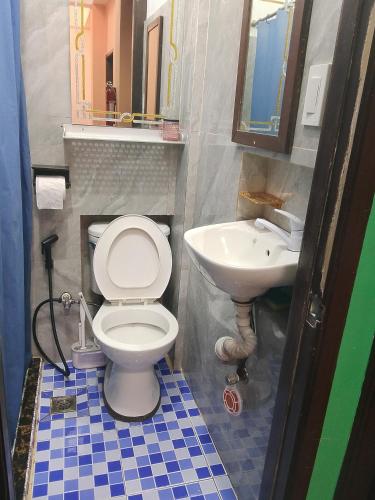 a bathroom with a toilet and a sink at Tipid Camp Baguio A2,A3,A7,A8 in Baguio