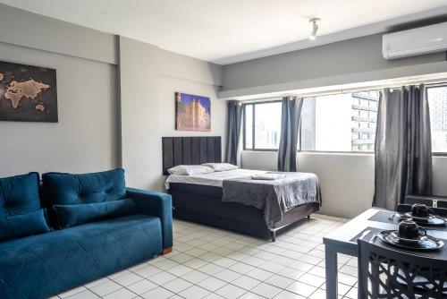 a living room with a bed and a couch at No coração do Recife in Recife