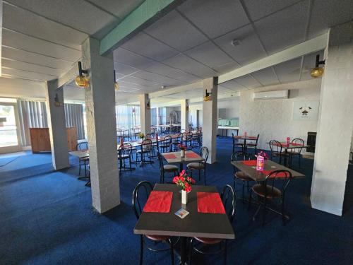 a dining room with tables and chairs in a building at Commercial Hotel in Birchip