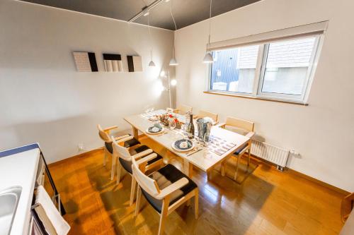 a dining room with a table and chairs at THE WORLDWIDE HOUSE in Sapporo