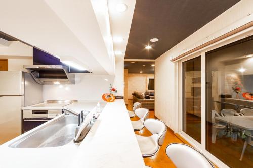 a kitchen with a sink and a table and chairs at THE WORLDWIDE HOUSE in Sapporo