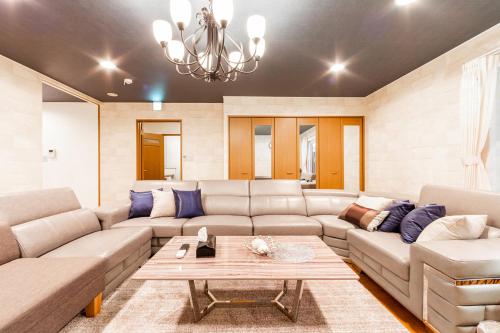 a living room with a couch and a table at THE WORLDWIDE HOUSE in Sapporo