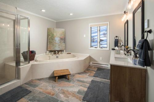 a large bathroom with a tub and a window at The Buc's Den in Beech Mountain