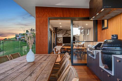 a kitchen and dining room with a wooden table at The Ridge at Maleny Deluxe Residence - Panoramic Valley Views in Maleny