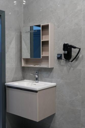 a bathroom with a sink and a mirror at AURA hotel in Taraz