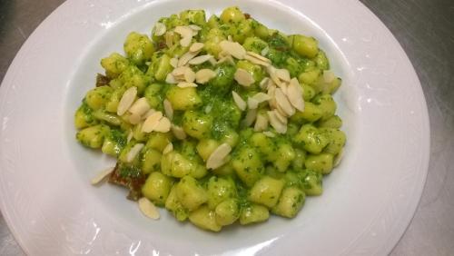 a white plate of food with broccoli and onions at Locanda dell'Arcangelo in Rocca Massima