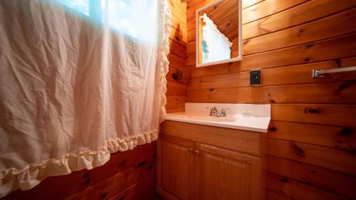 a bathroom with a sink and a mirror at Stunning Lakeview Muskoka Pier 100 Resort in Port Carling