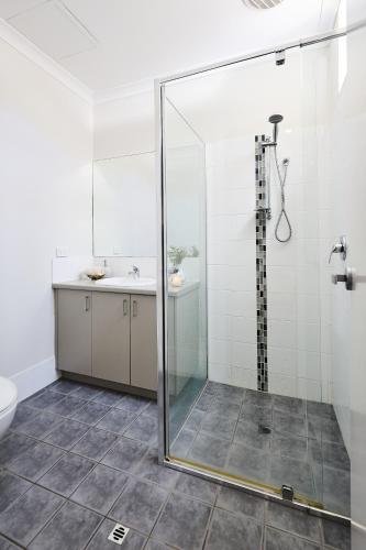 a bathroom with a shower and a sink at Water's Edge 4x4 Townhouse in Falcon