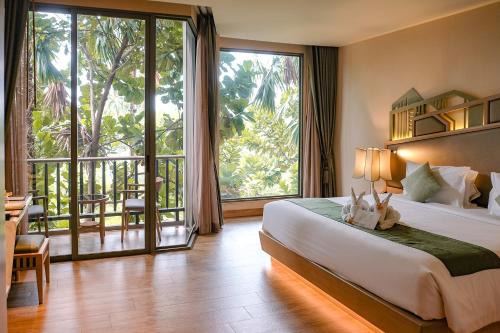 a hotel room with a bed and a large window at W1Bangkoknoi Hotel in Nonthaburi