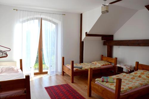 a bedroom with two beds and a large window at Agrotur-Maya in Gorzyca