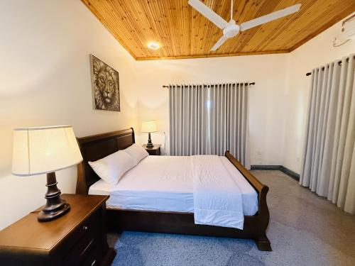 a bedroom with a bed and a ceiling fan at Lone Star Residence in Jaffna