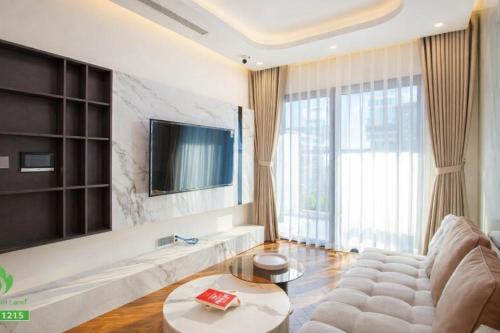 a living room with a couch and a tv at Thuý Doji Diamond Apartment in Hai Phong
