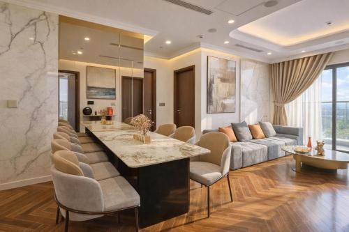 a kitchen and living room with a couch and a table at Thuý Doji Diamond Apartment in Hai Phong