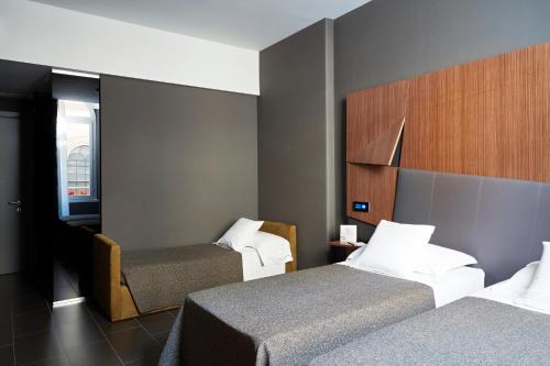 Ένα ή περισσότερα κρεβάτια σε δωμάτιο στο Hotel The Building
