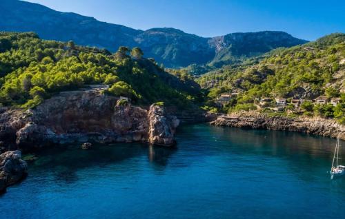 an aerial view of a river with mountains at Amaret in Deia