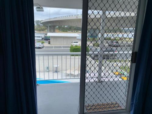 an open window with a view of a parking lot at Batemans Bay Lodge in Batemans Bay