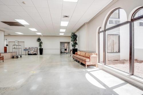 a large room with a couch and windows at Cottonwood Suites Savannah Hotel & Conference Center in Pooler