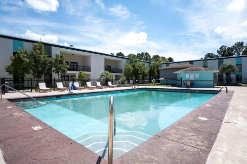 a large swimming pool in front of a building at Cottonwood Suites Savannah Hotel & Conference Center in Pooler