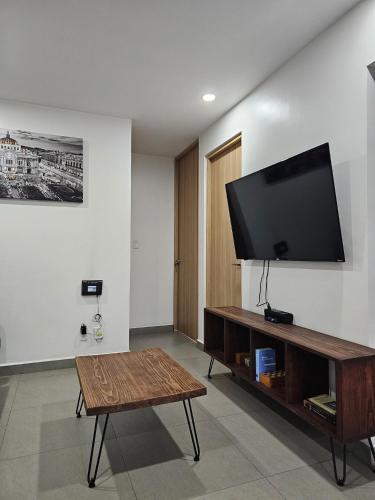 a living room with a flat screen tv on a wall at NSI Alameda Park Humboldt Mexico City in Mexico City
