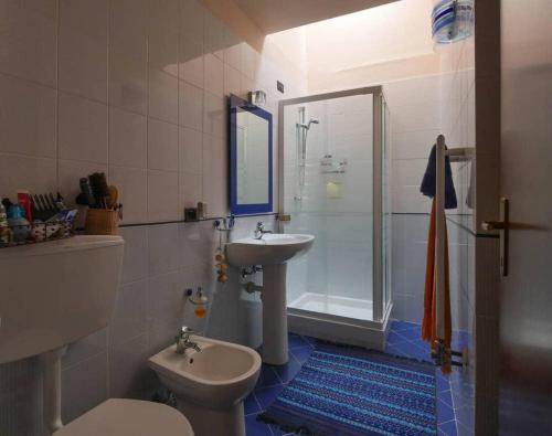a bathroom with a toilet and a sink and a shower at Casa Melabruna, 5 terre biker friendly in Pignone