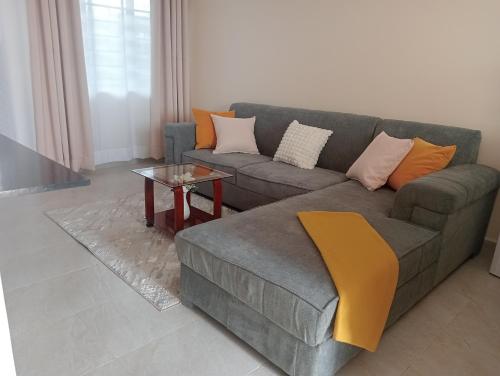 a living room with a couch and a table at Shanvinhomes -1 bedroom Apartment in Skuta-Nyeri Town in Nyeri