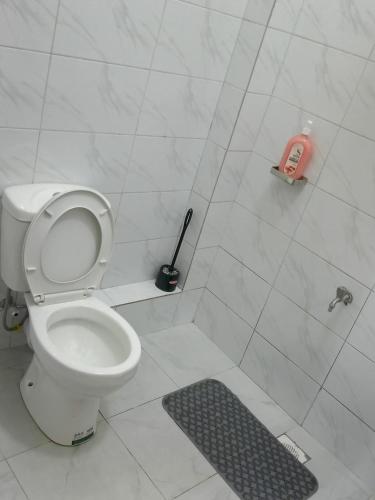 a bathroom with a toilet and a shower stall at Shanvinhomes -1 bedroom Apartment in Skuta-Nyeri Town in Nyeri