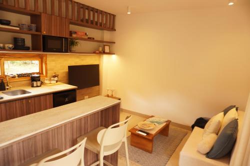 a living room with a couch and a kitchen at Hermosa casita frente al mar en San Jose - Olon in San José