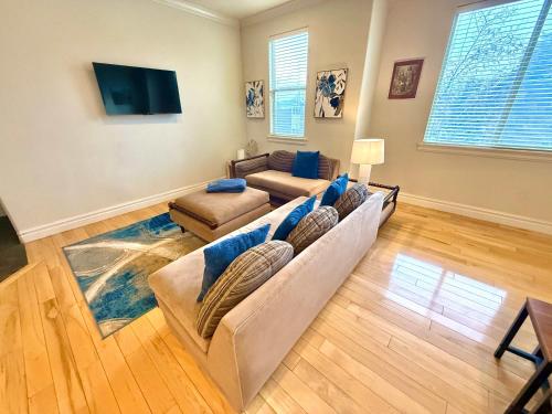a living room with a couch and a tv at Spacious Townhome Near Downtown in Salt Lake City