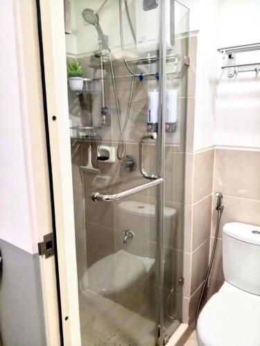 a shower with a glass door in a bathroom at Haute Haven - 1br with Balcony in Manila