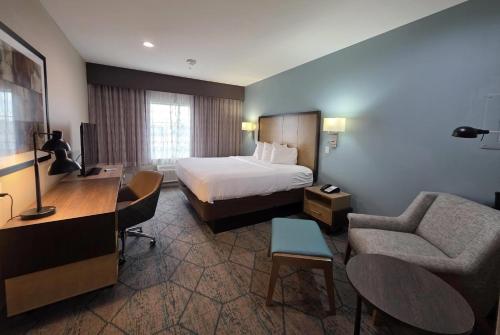 a hotel room with a bed and a desk at Hawthorn Extended Stay by Wyndham Corpus Christi I-37 NW in Corpus Christi