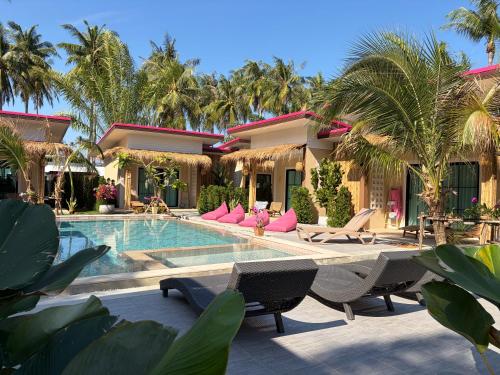 a resort with a swimming pool and palm trees at Pinky Bungalows Resort & Villa in Ko Lanta