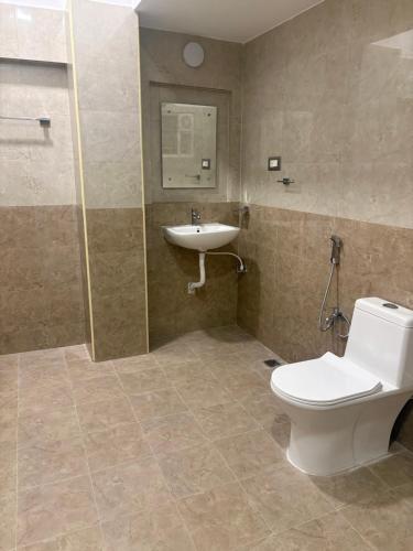 a bathroom with a toilet and a sink at Eiffel Pondy in Pondicherry