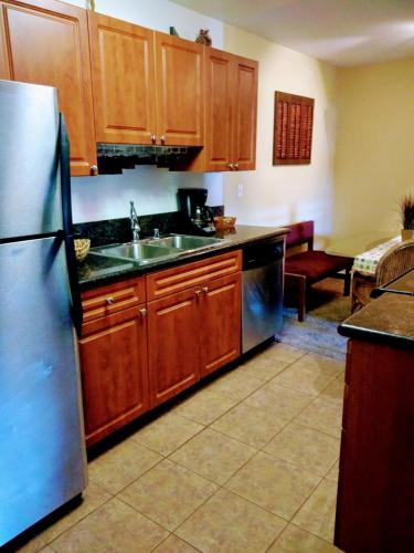 a kitchen with wooden cabinets and a stainless steel refrigerator at Departamento completo en San Diego & Bonita You can ask for 30 or more days book and save aditional 15 percent in San Diego