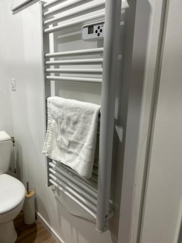 a towel hanging on a towel rack in a bathroom at L Écrin d or in Montluçon