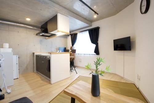 a kitchen and living room with a table and a refrigerator at FelizLife 南馬込 201 in Tokyo