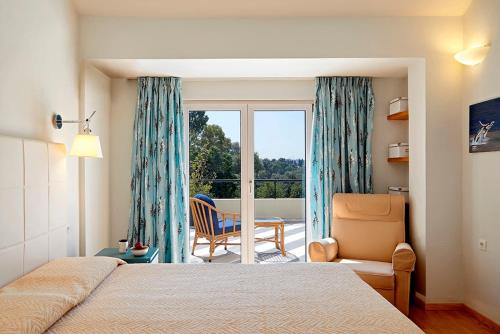 a bedroom with a bed and a room with a balcony at Helion Apartments - Parallel in Gouvia
