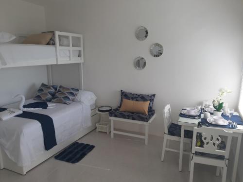 a bedroom with a bunk bed and a desk and a bed and a desk at Casablanca207 in Acapulco