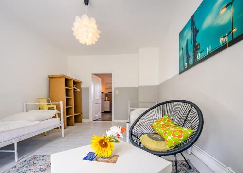 a living room with a chair and a couch at Seeblick Bed & Breakfast in Lassahn