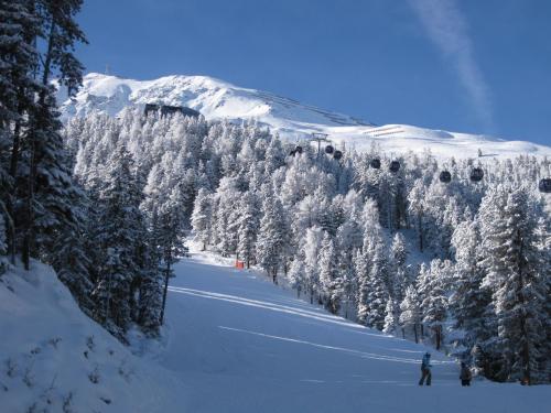 a person is skiing down a snow covered mountain at Hotel Neue Post in Sölden