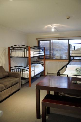 a living room with two bunk beds and a couch at Arlberg Hotham in Mount Hotham