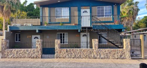a house with a staircase in front of it at Casas centro Loreto in Loreto