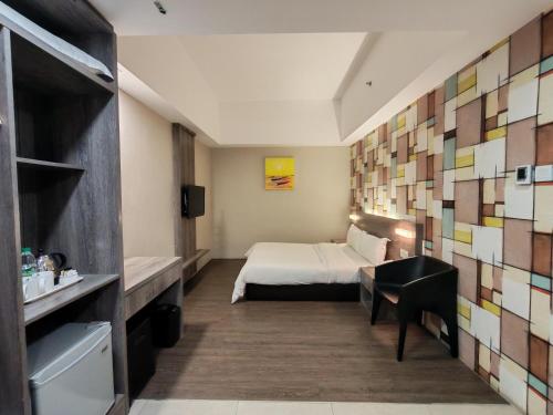 a hotel room with a bed and a desk at Ajang Hotel in Miri