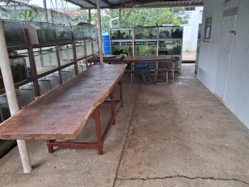 a wooden bench sitting inside of a building at Fortune Room Stay no1 in Sandakan