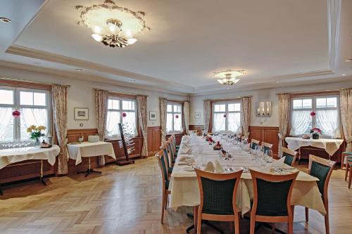 a conference room with tables and chairs and windows at Gasthof Eisenbahn in Weinfelden
