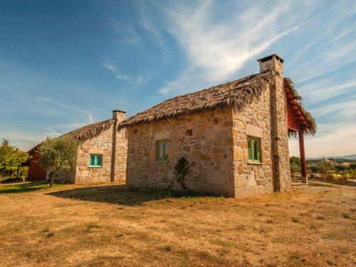 an old stone building with a grass roof at Chão do Rio - Turismo de Aldeia in Seia