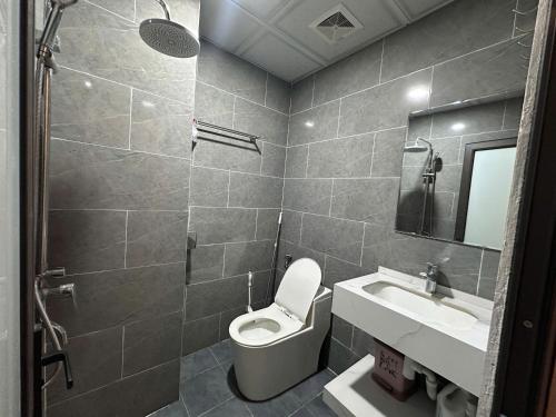 a bathroom with a toilet and a sink at Urban Nest - Đông Ngạc in Hanoi