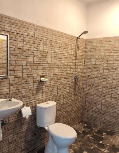 a bathroom with a toilet and a sink at Anugrah Hotel Teluk Nara in Teluknarat