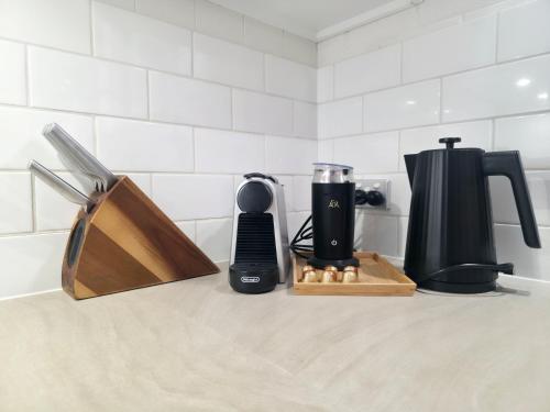 a kitchen counter with a coffee maker and a blender at The Hideaway - Lake Views I Ski & Bike Storage I Central Jindabyne I Free WiFi I BBQ I Parking in Jindabyne